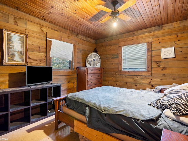 carpeted bedroom featuring ceiling fan, wooden walls, and wood ceiling