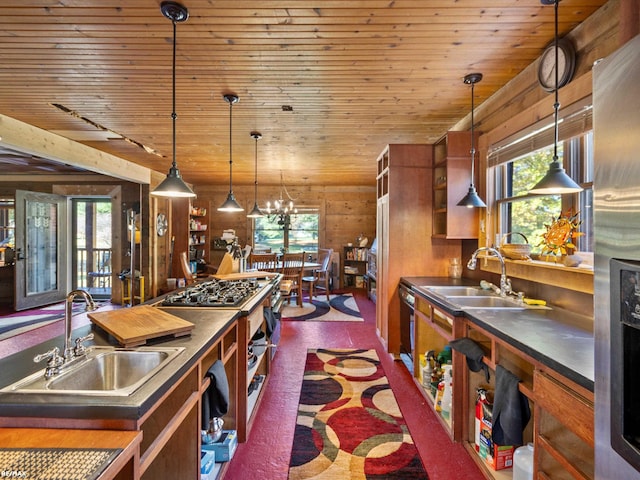 kitchen featuring decorative light fixtures, a wealth of natural light, and sink