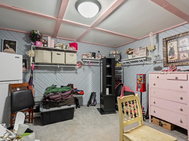 interior space with white refrigerator and wooden walls