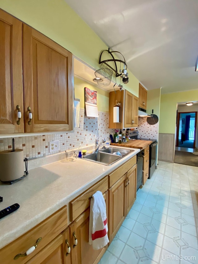 kitchen with backsplash, sink, black dishwasher, stainless steel electric range oven, and light tile patterned flooring