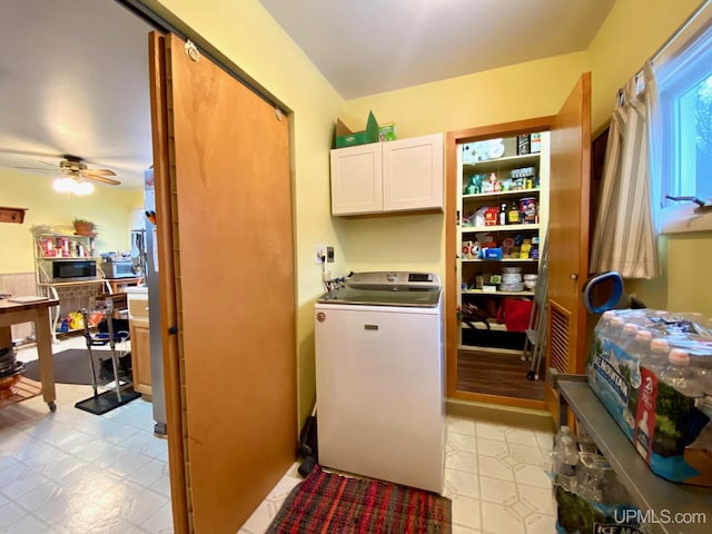 clothes washing area with ceiling fan, cabinets, and washer / clothes dryer