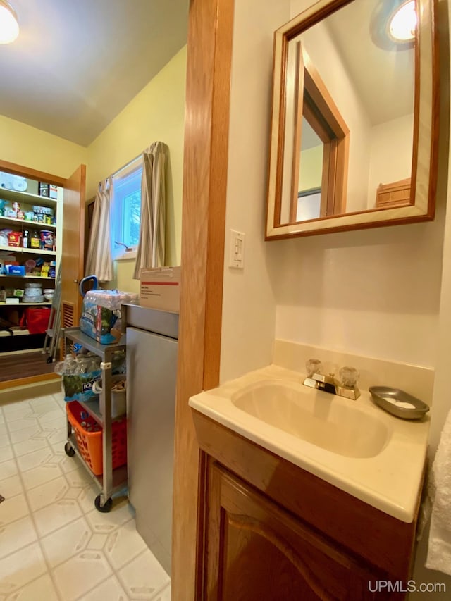 bathroom with tile patterned flooring and vanity