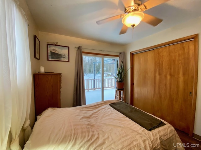 bedroom featuring access to outside, ceiling fan, and a closet