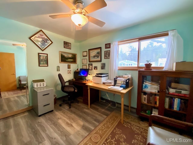 home office with wood-type flooring and ceiling fan