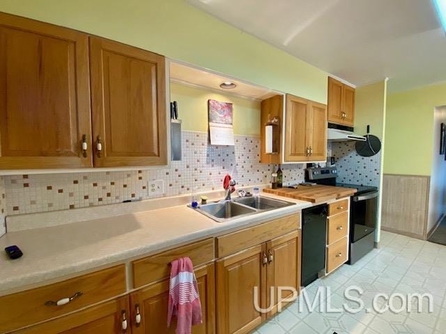 kitchen with decorative backsplash, sink, and black appliances