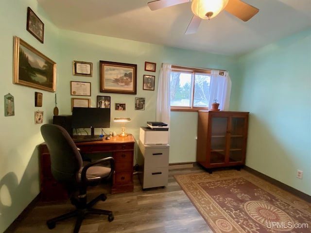 office area with light hardwood / wood-style flooring and ceiling fan