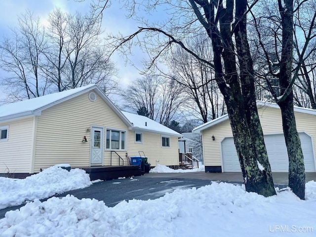 view of snow covered back of property