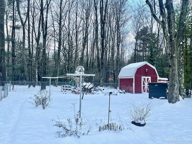 yard layered in snow with an outdoor structure