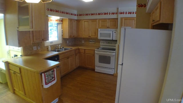 kitchen with white appliances, sink, light wood-type flooring, light brown cabinetry, and tasteful backsplash