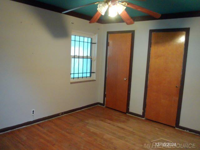 unfurnished bedroom with light hardwood / wood-style floors and ceiling fan