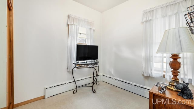 interior space featuring baseboard heating and light carpet