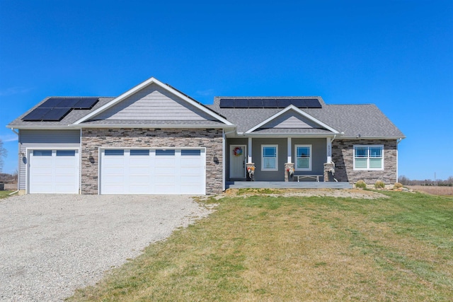 craftsman-style house with solar panels, a porch, a garage, and a front lawn