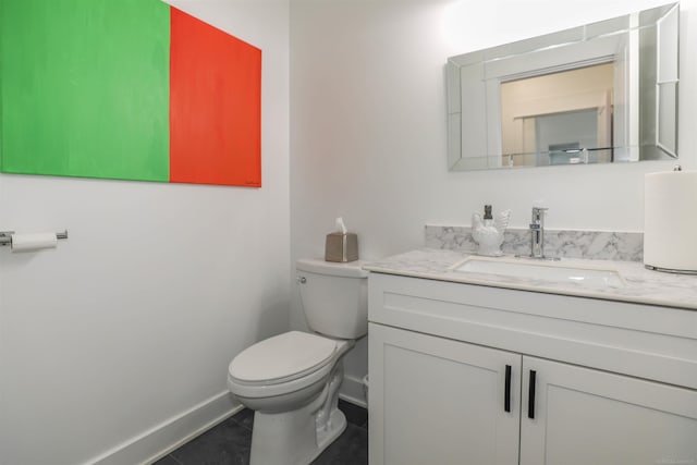 bathroom featuring tile patterned floors, vanity, and toilet