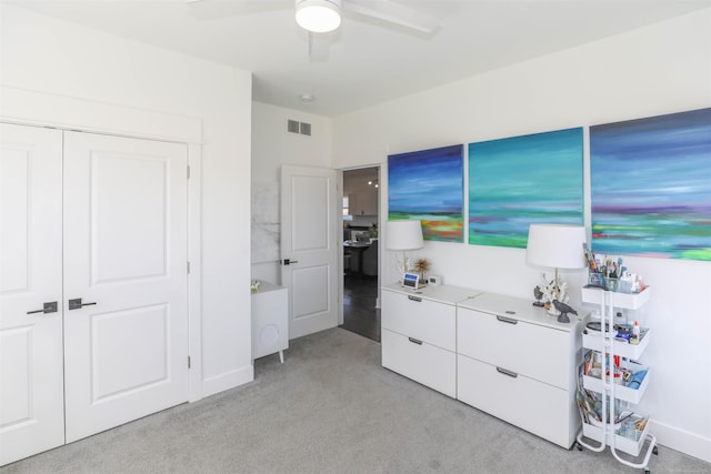 bedroom with ceiling fan, a closet, and light colored carpet