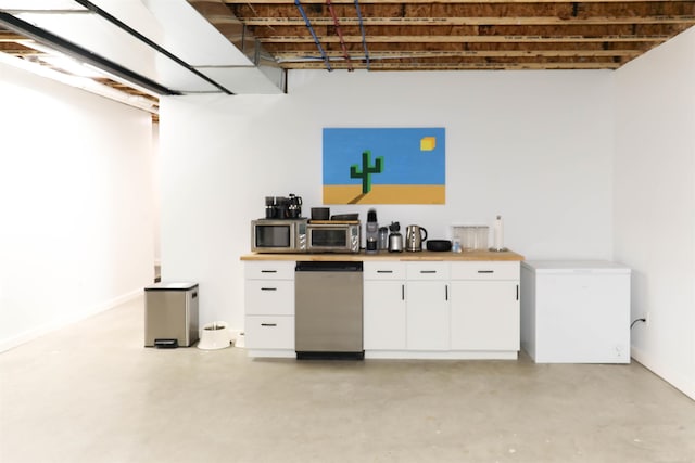 interior space with butcher block countertops, white cabinetry, and appliances with stainless steel finishes