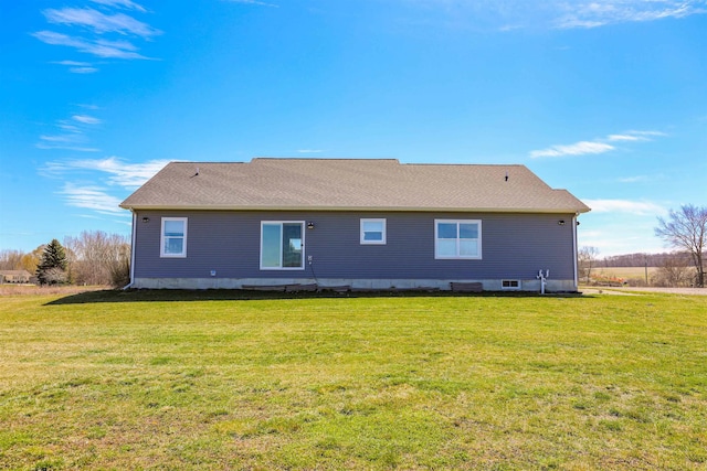 rear view of house with a yard