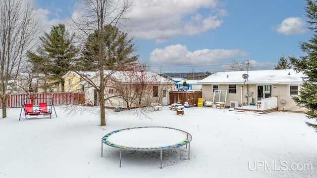 snow covered property featuring a trampoline