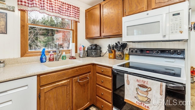 kitchen featuring sink and white appliances