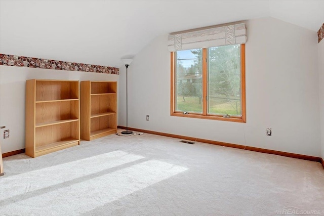 bonus room featuring light colored carpet and lofted ceiling