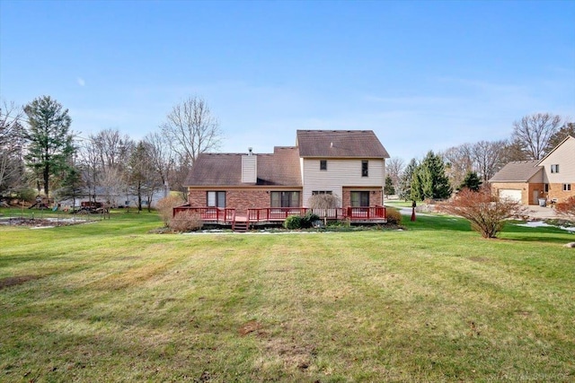 rear view of house featuring a yard and a wooden deck