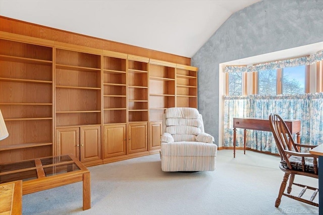 sitting room with light carpet and vaulted ceiling