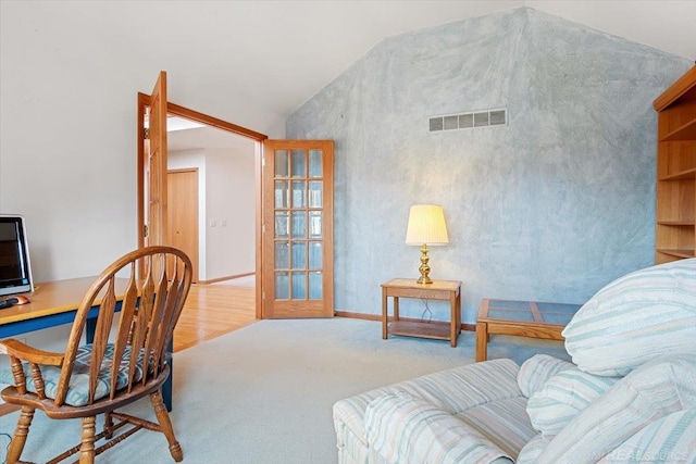 carpeted office featuring french doors and lofted ceiling