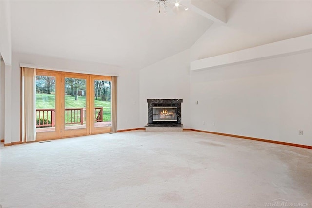 unfurnished living room featuring carpet flooring, a high end fireplace, ceiling fan, high vaulted ceiling, and beamed ceiling