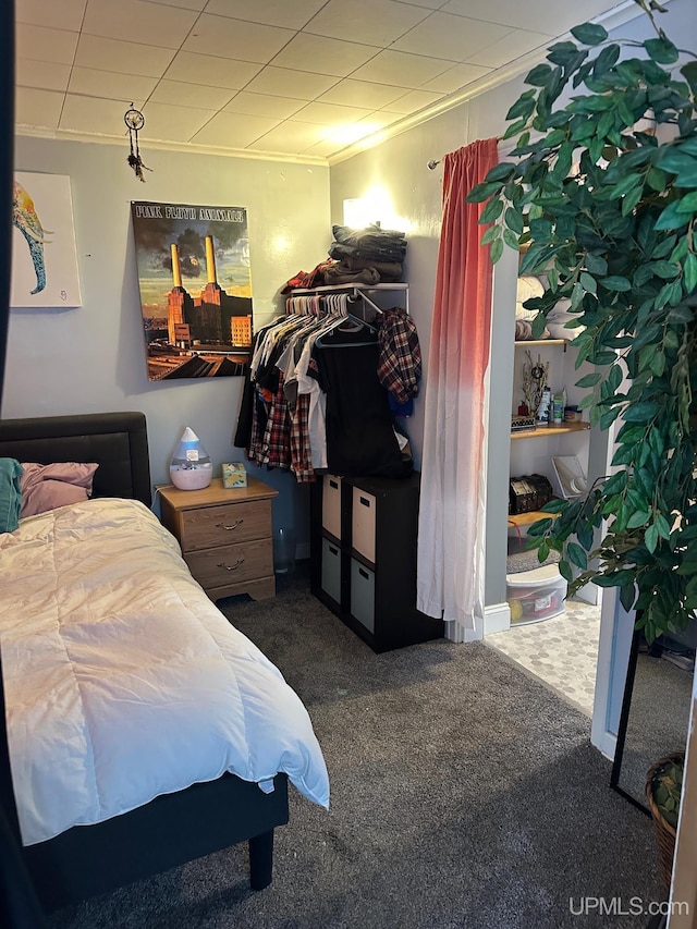 bedroom with carpet flooring and crown molding