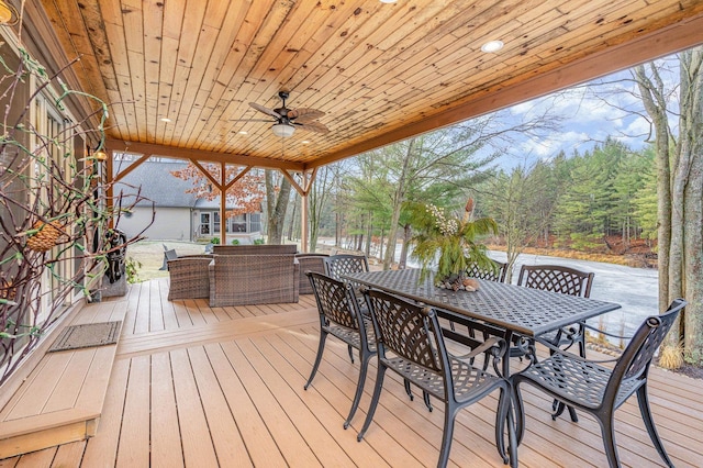 wooden terrace with ceiling fan and an outdoor hangout area