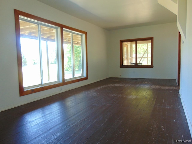 spare room featuring dark hardwood / wood-style flooring