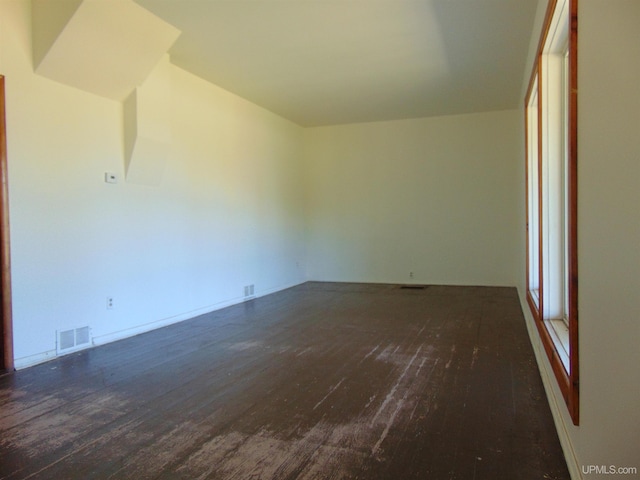 spare room featuring dark hardwood / wood-style flooring