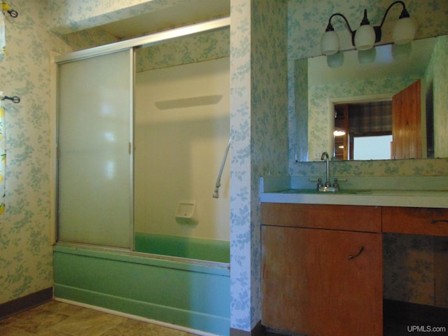 bathroom featuring vanity and combined bath / shower with glass door