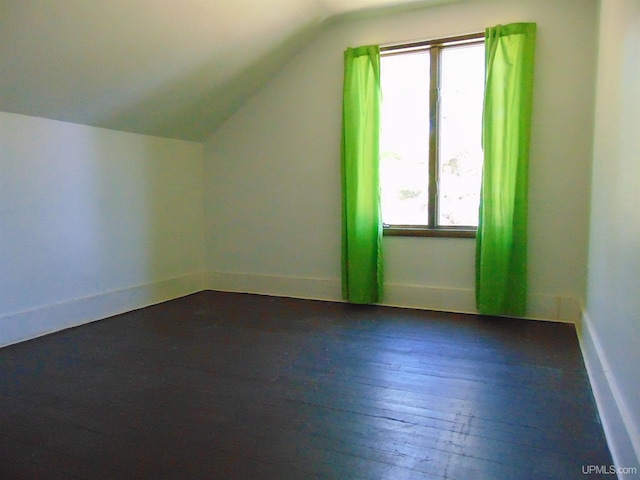 bonus room featuring plenty of natural light, wood-type flooring, and vaulted ceiling