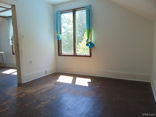 bonus room featuring dark hardwood / wood-style flooring and vaulted ceiling