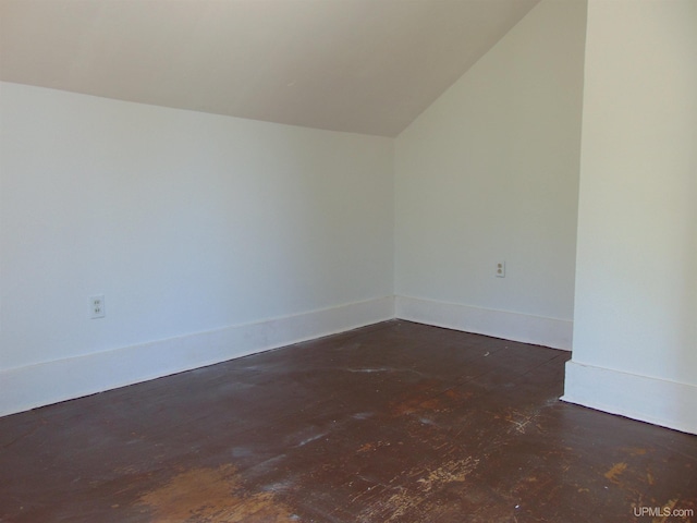 empty room featuring lofted ceiling