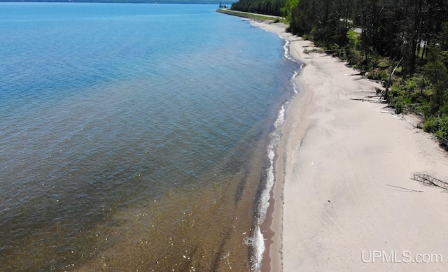 drone / aerial view featuring a water view and a beach view