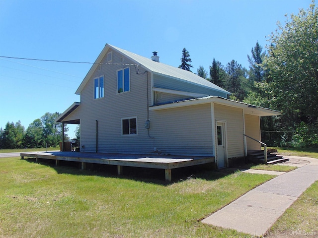 rear view of property featuring a yard