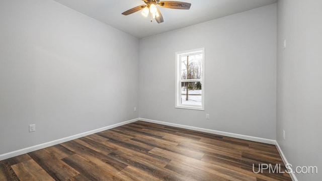 spare room with ceiling fan and dark hardwood / wood-style flooring