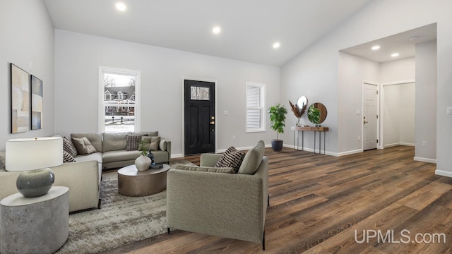 living room with high vaulted ceiling and dark wood-type flooring