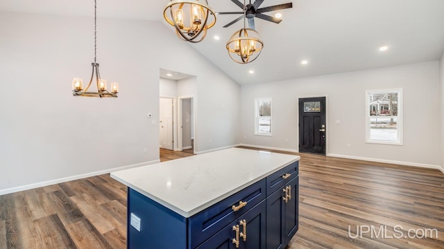 kitchen with a kitchen island, dark hardwood / wood-style flooring, blue cabinetry, high vaulted ceiling, and ceiling fan