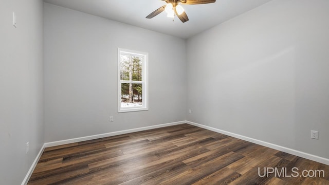 spare room featuring ceiling fan and dark hardwood / wood-style floors