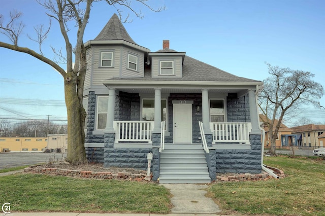 view of front facade with a porch and a front lawn