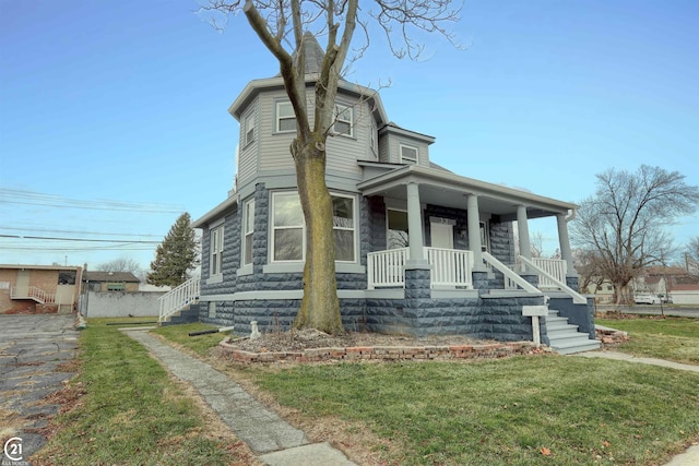 view of front of house with covered porch and a front yard