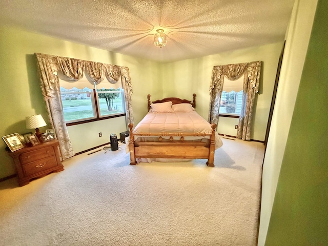 bedroom with ceiling fan, carpet, and a textured ceiling