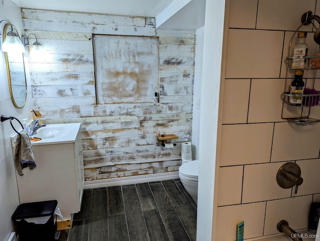 bathroom featuring hardwood / wood-style floors, vanity, and toilet