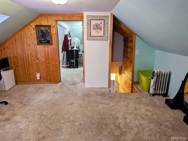 bonus room with carpet floors, vaulted ceiling, and wooden walls