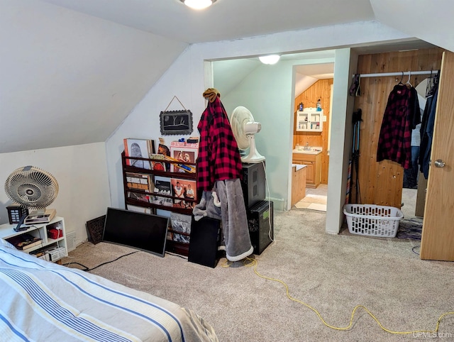 bedroom featuring carpet flooring, lofted ceiling, and wooden walls