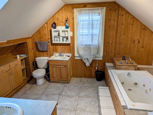 bathroom featuring vanity, wood walls, lofted ceiling, a washtub, and toilet