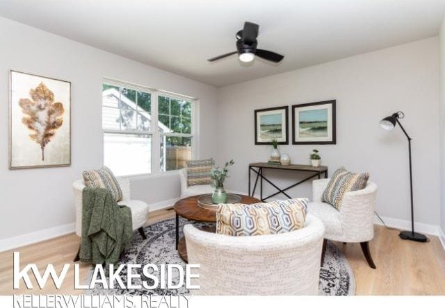 living room featuring hardwood / wood-style flooring and ceiling fan