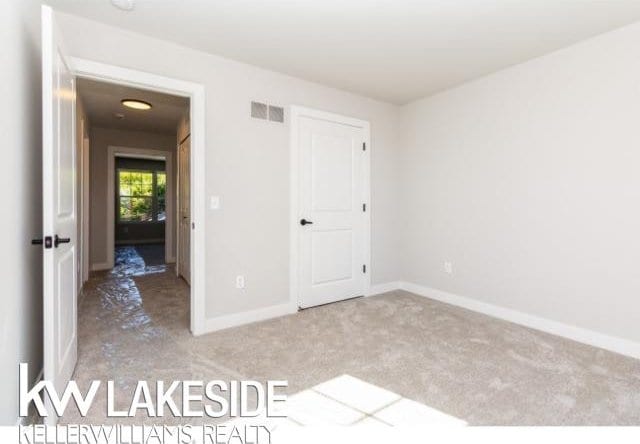 unfurnished bedroom with light carpet